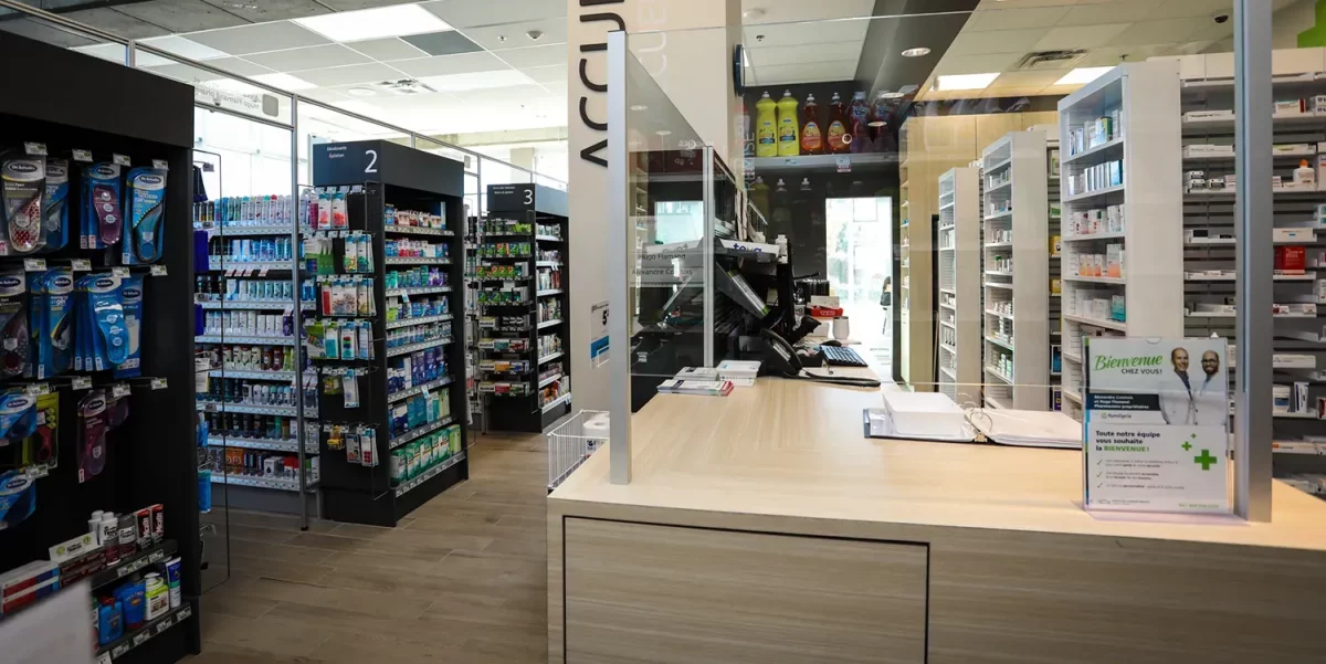 Entrée et zone d'accueil avec panneau Bienvenue et allées de produits – pharmacie Familiprix Joliette par BGC